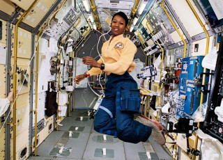 Mae Jemison aboard a spacecraft floats in zero gravity.