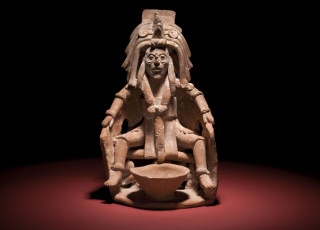 A figurine part of a Mayan blood letting bowl