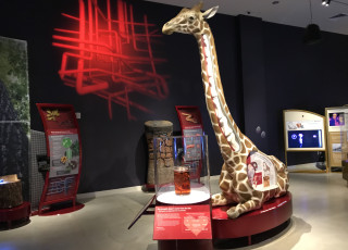 A model of a giraffe inside the exhibit