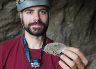 Kaedan O&#039;Brien holds a mummified rodent found in a cave. 