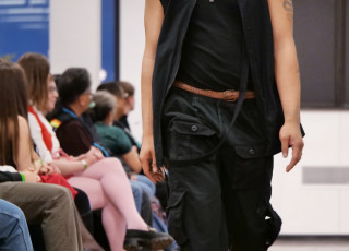 A young man models an all black outfit